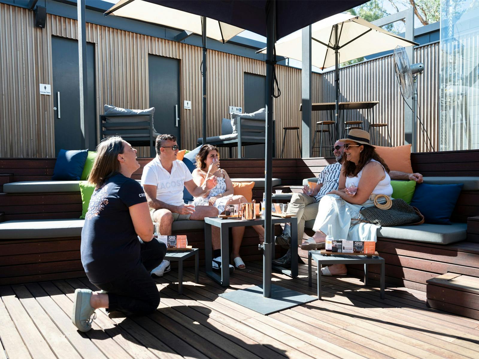People sitting in the sun on the deck at SRD
