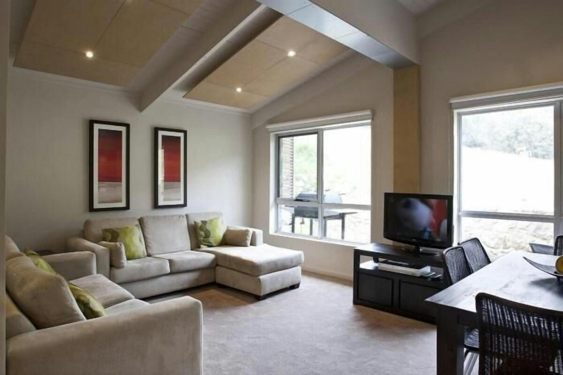 open living room with big windows and a television