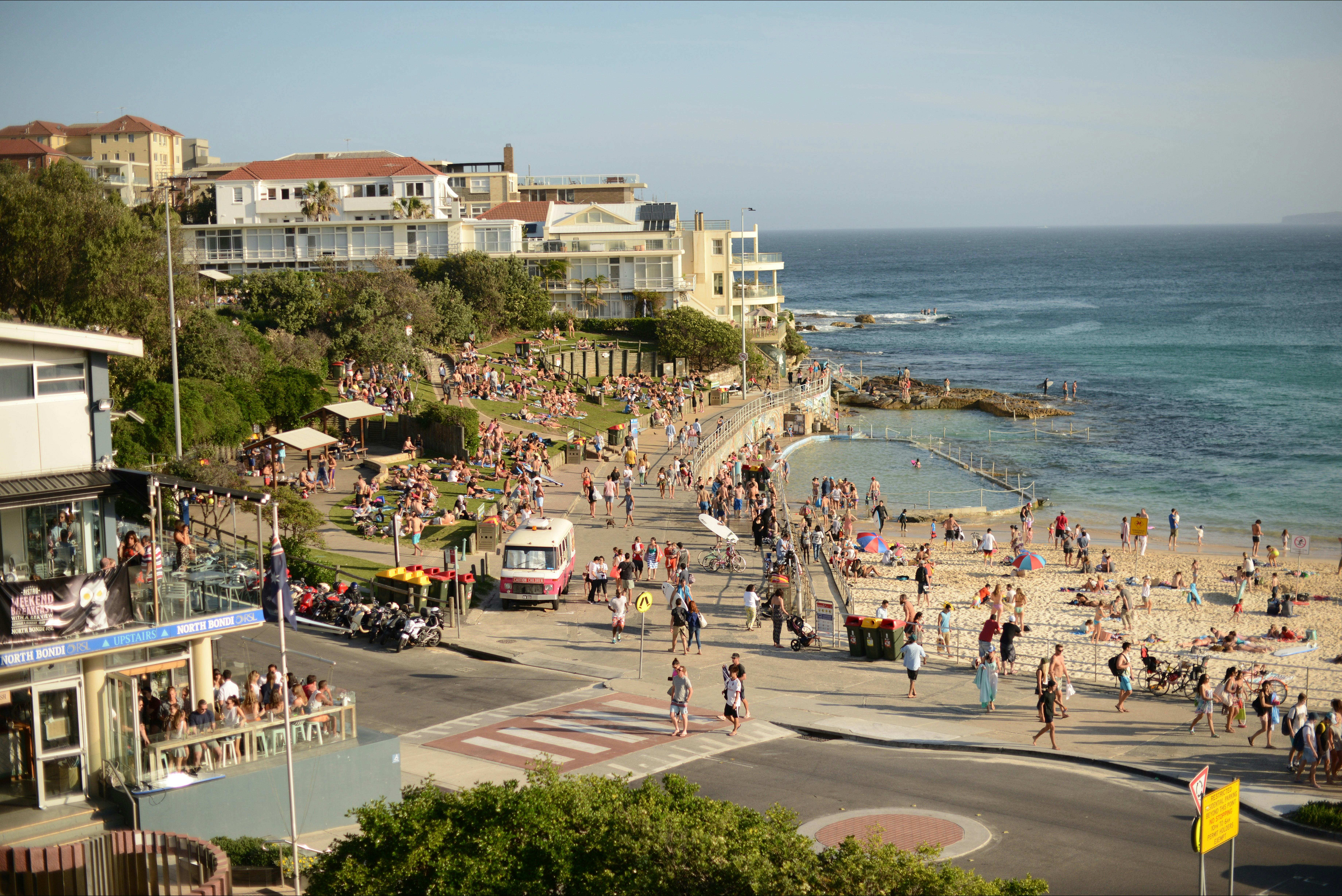 Another stop of Sydney bus tour at Bondi Beach. A lot of people on the sand sunbathing and relaxing.
