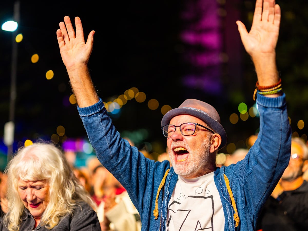 Man waving his arms in the crowd