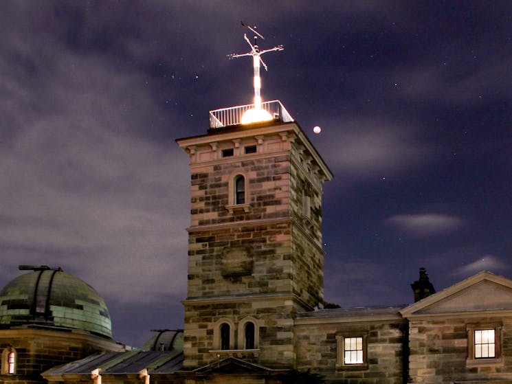 Nighttime view of illuminated tower at Sydney Observatory