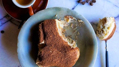 Italian dessert plated on a table with coffee on the side
