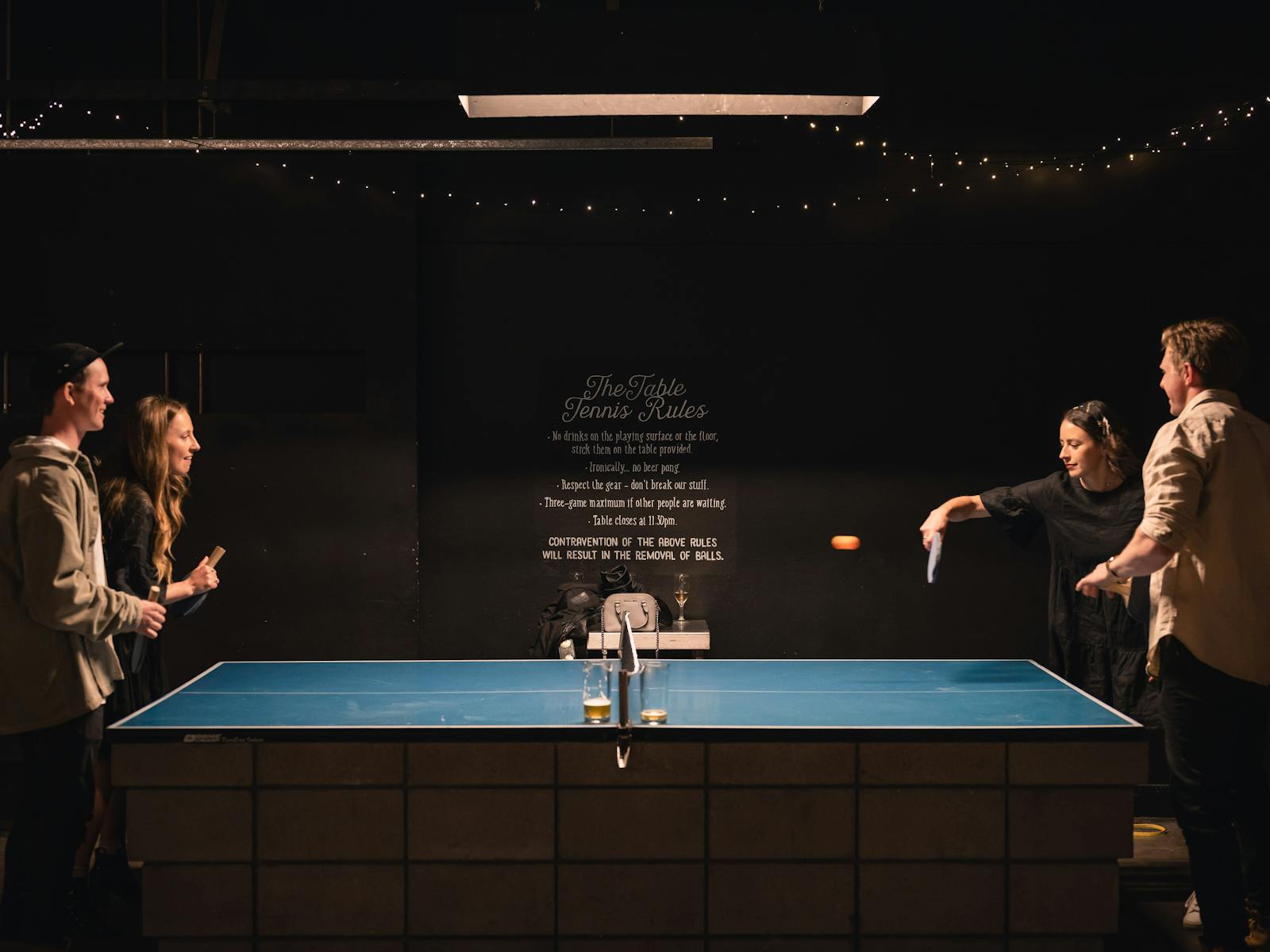 two couples playing table tennis