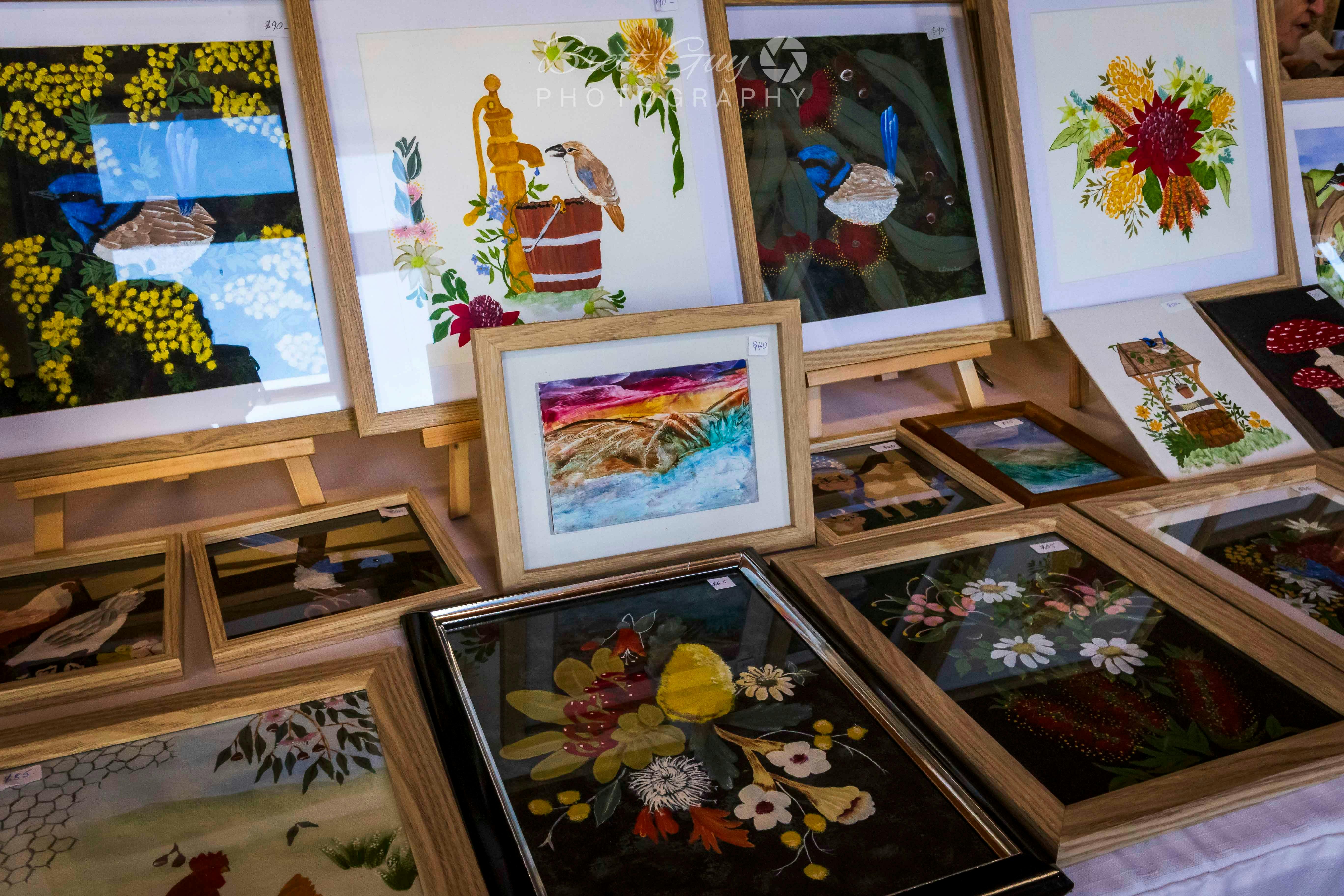 A collection of framed paintings including birds and flowers