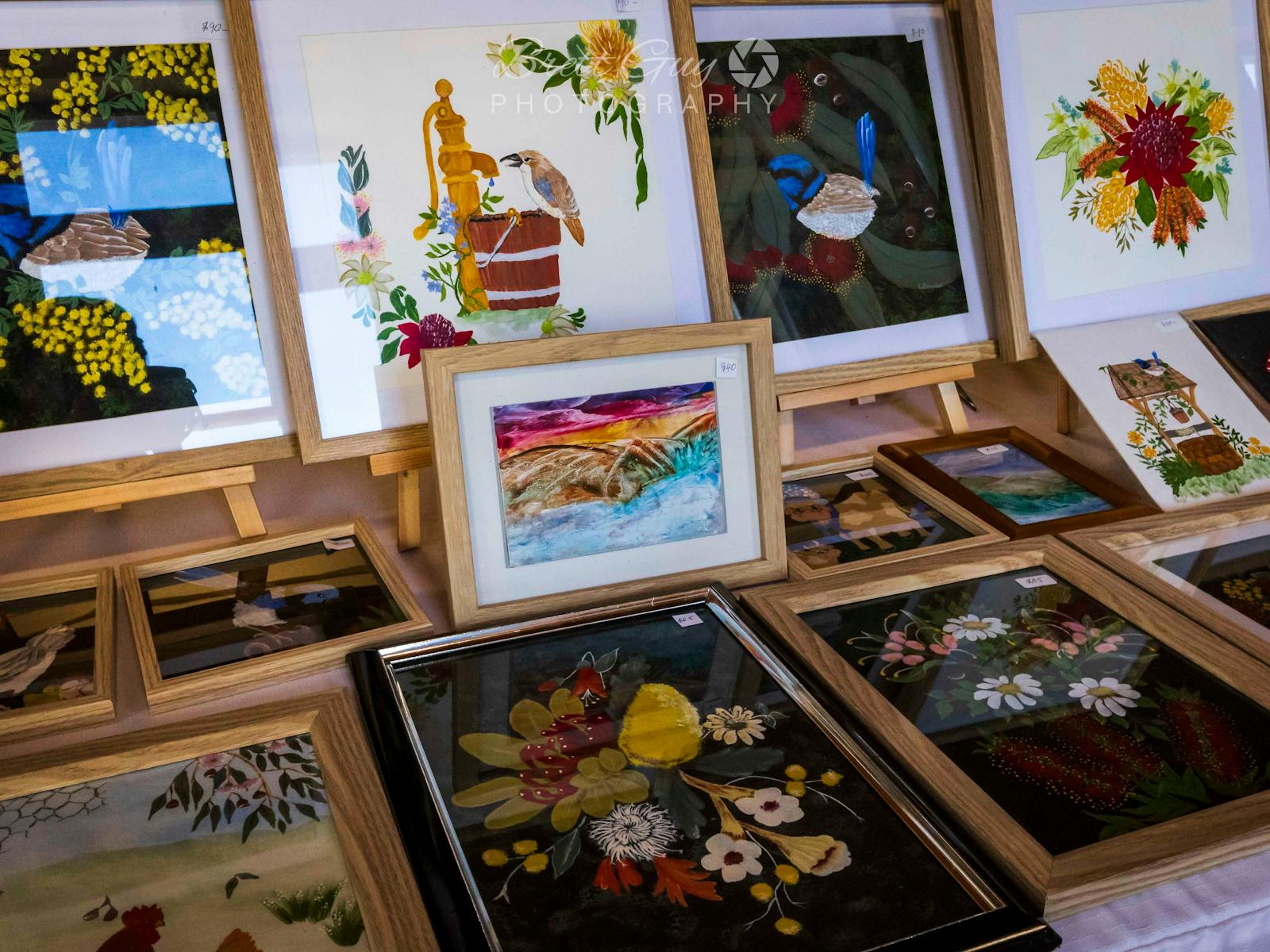 A collection of framed paintings including birds and flowers