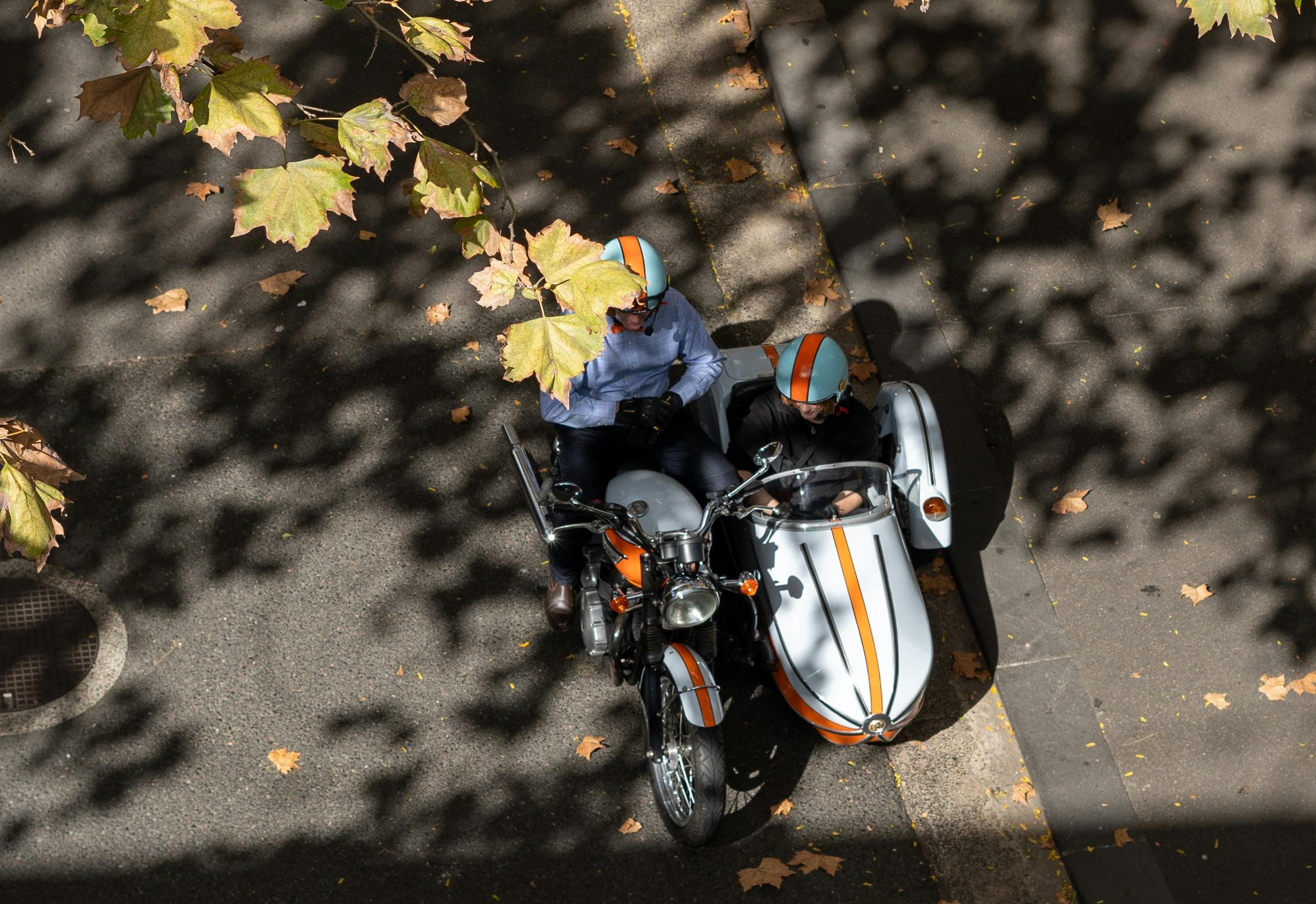 Overhead shot of motorbike and sidecar with a smiling rider and passenger