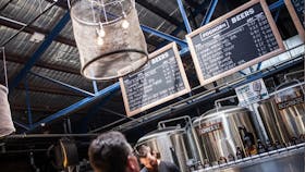 A customer viewing the beer menu  chalkboards which hang above the 16 taps and four serving tanks