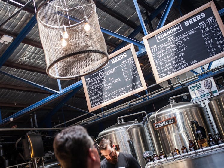 A customer viewing the beer menu  chalkboards which hang above the 16 taps and four serving tanks