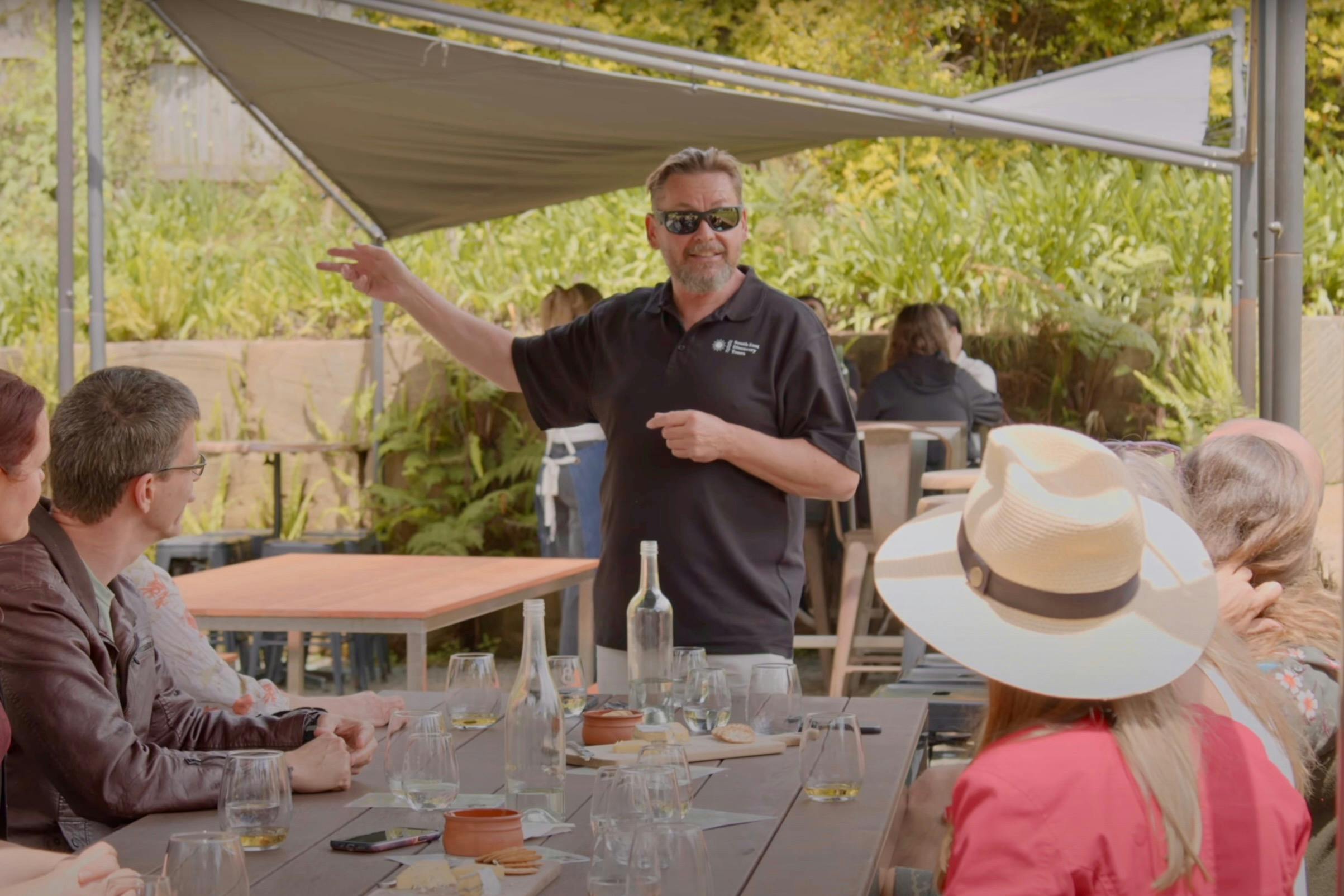 South East Discovery Tours guide, PJ, presenting wine to a tour group