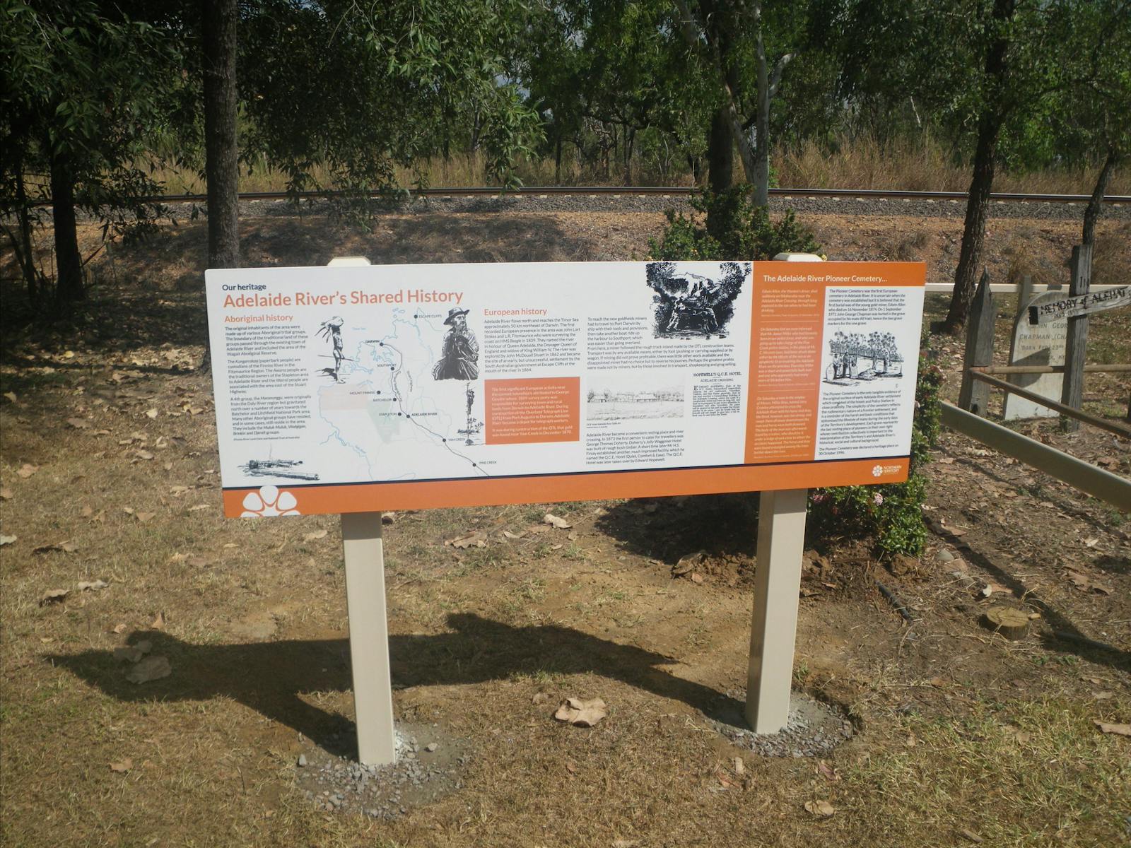 Freestanding interpretive sign at the Pioneer Cemetery detailing Adelaide River's shared heritage.