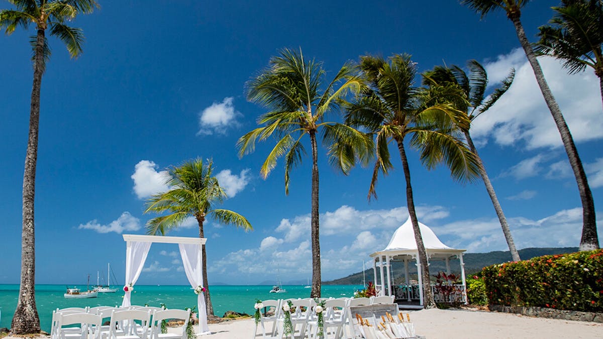 A wedding ceremony set up on The Beach at Coral Sea Marina Resort