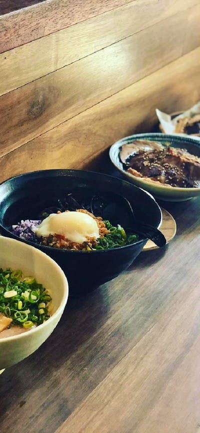 Bowls of ramen on long table
