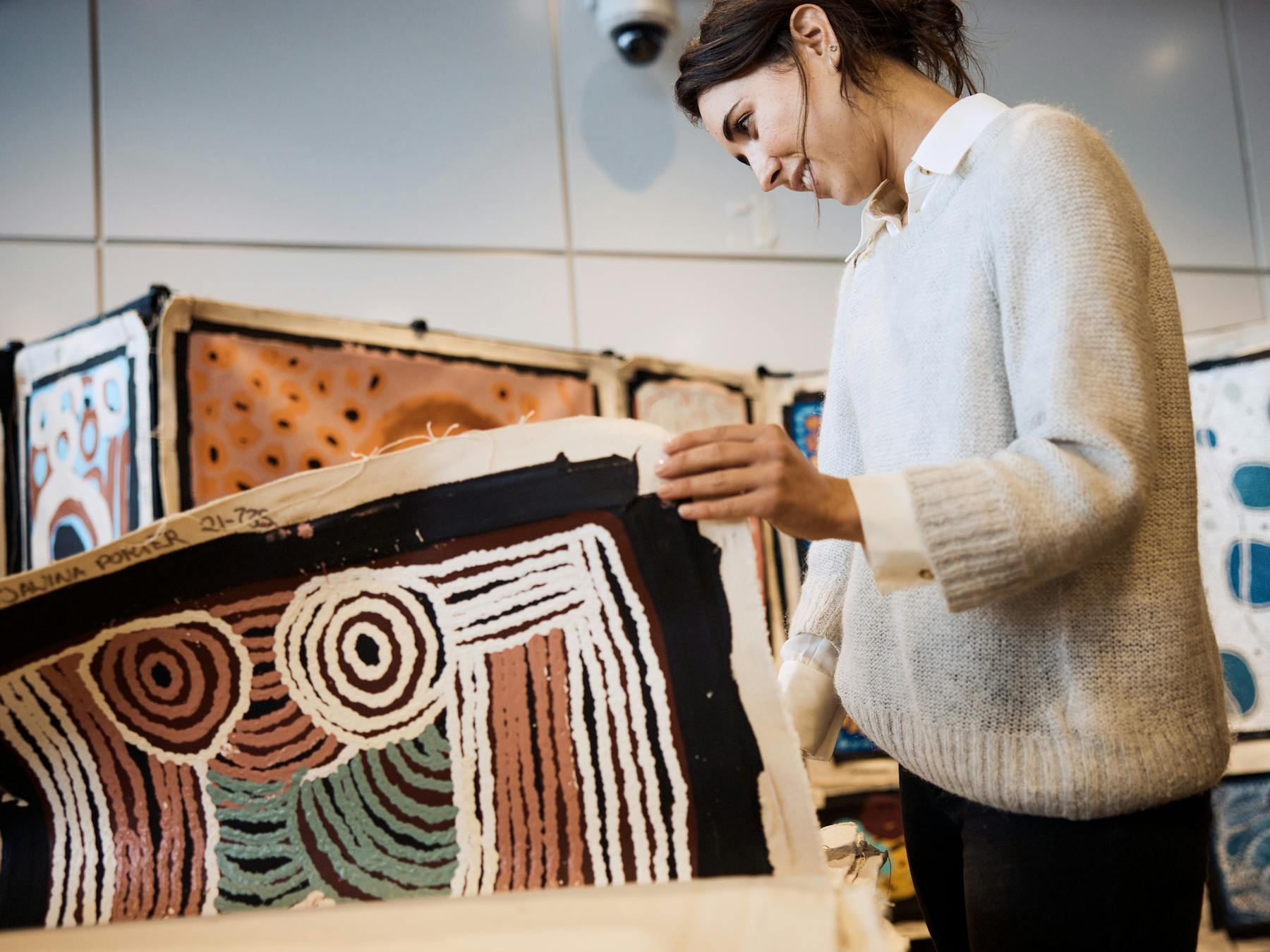 Woman exploring Aboriginal art in The Rocks.