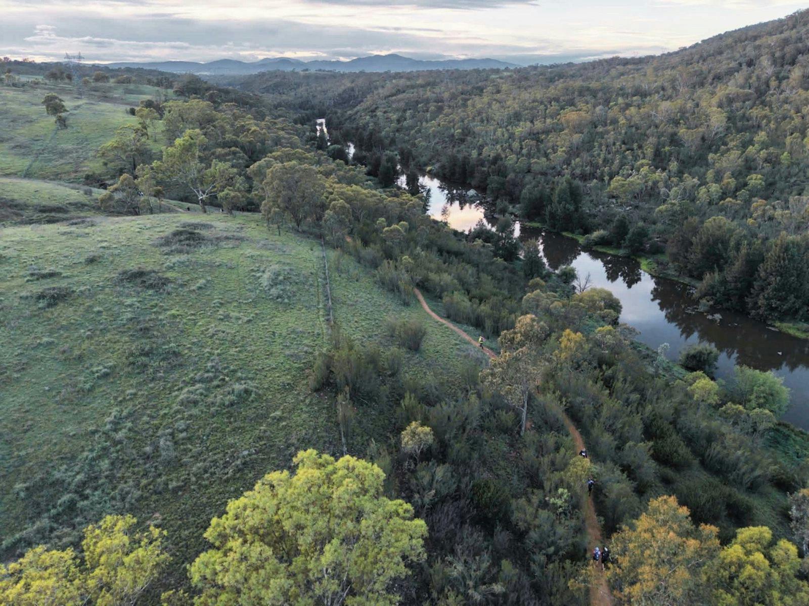 an arial photo of bushland and a river
