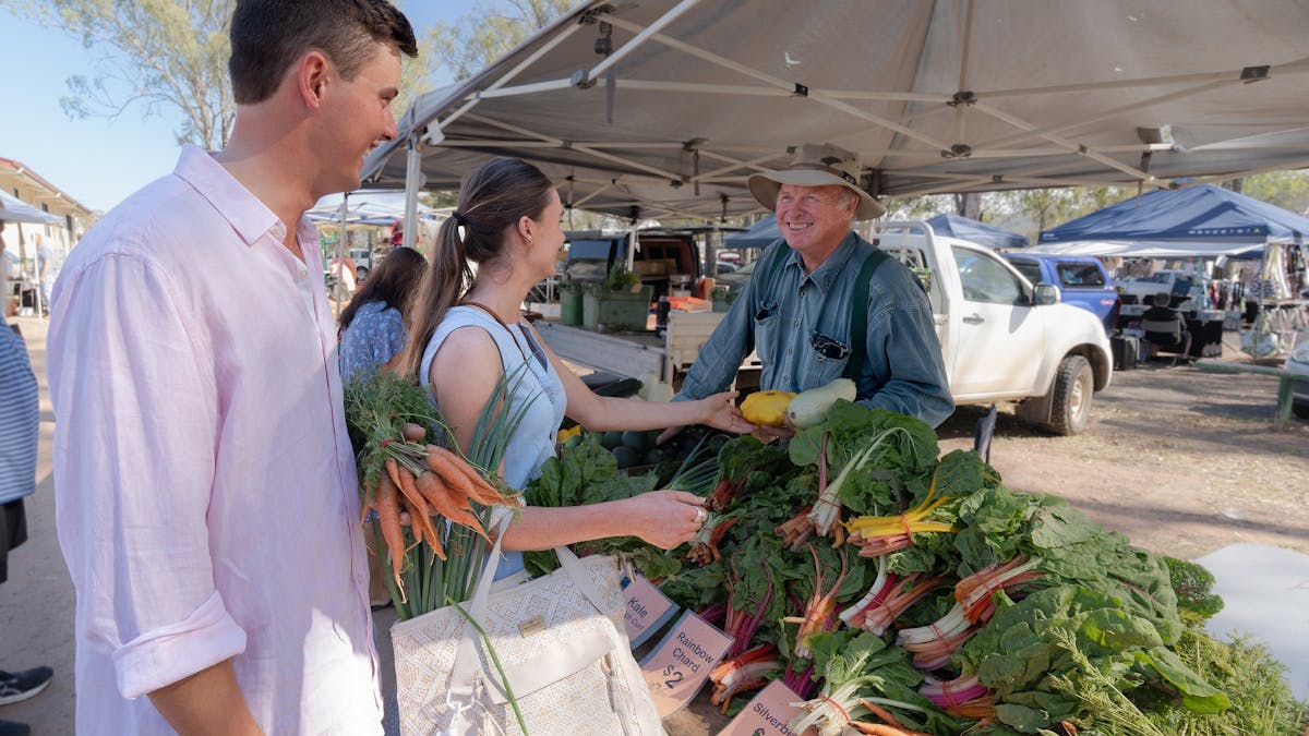 Couple buying farm fresh produce at the markets