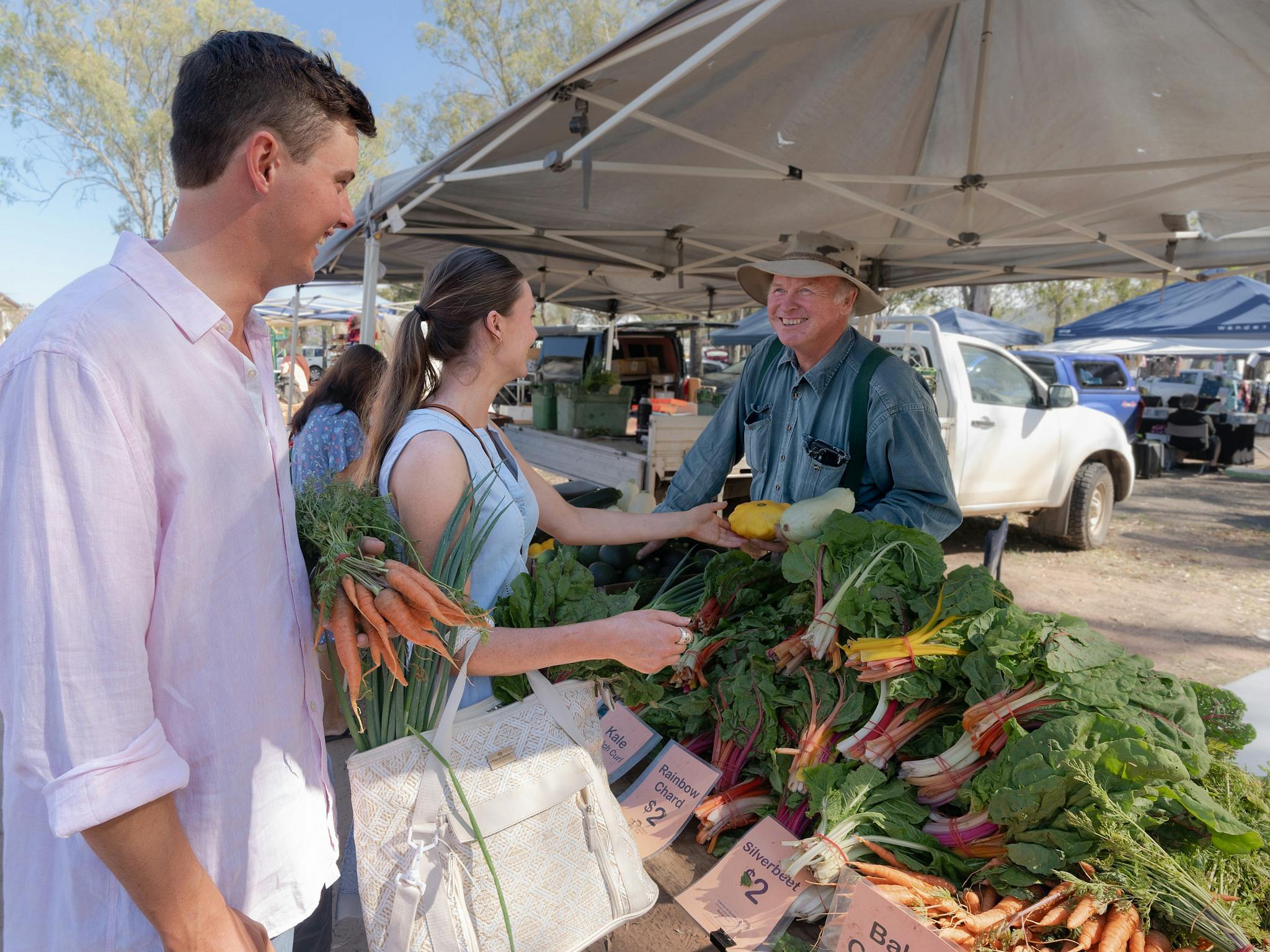Couple buying farm fresh produce at the markets Couple buying farm fresh produce at the markets