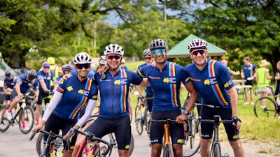 Four cyclists casually on bikes not riding inc. Ch7's Mark Beretta at the end of Signature Tour '25