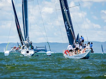 two sailing boats racing across the ocean two sailing boats racing across the ocean