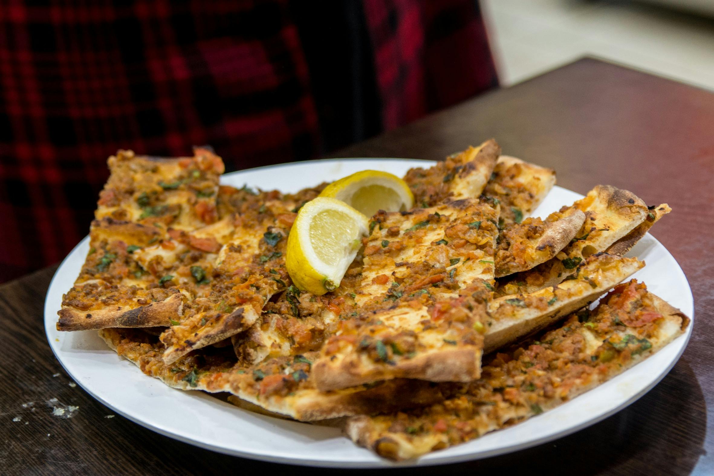 Turkish Pizza covered with mince meat and a wedge of lemon