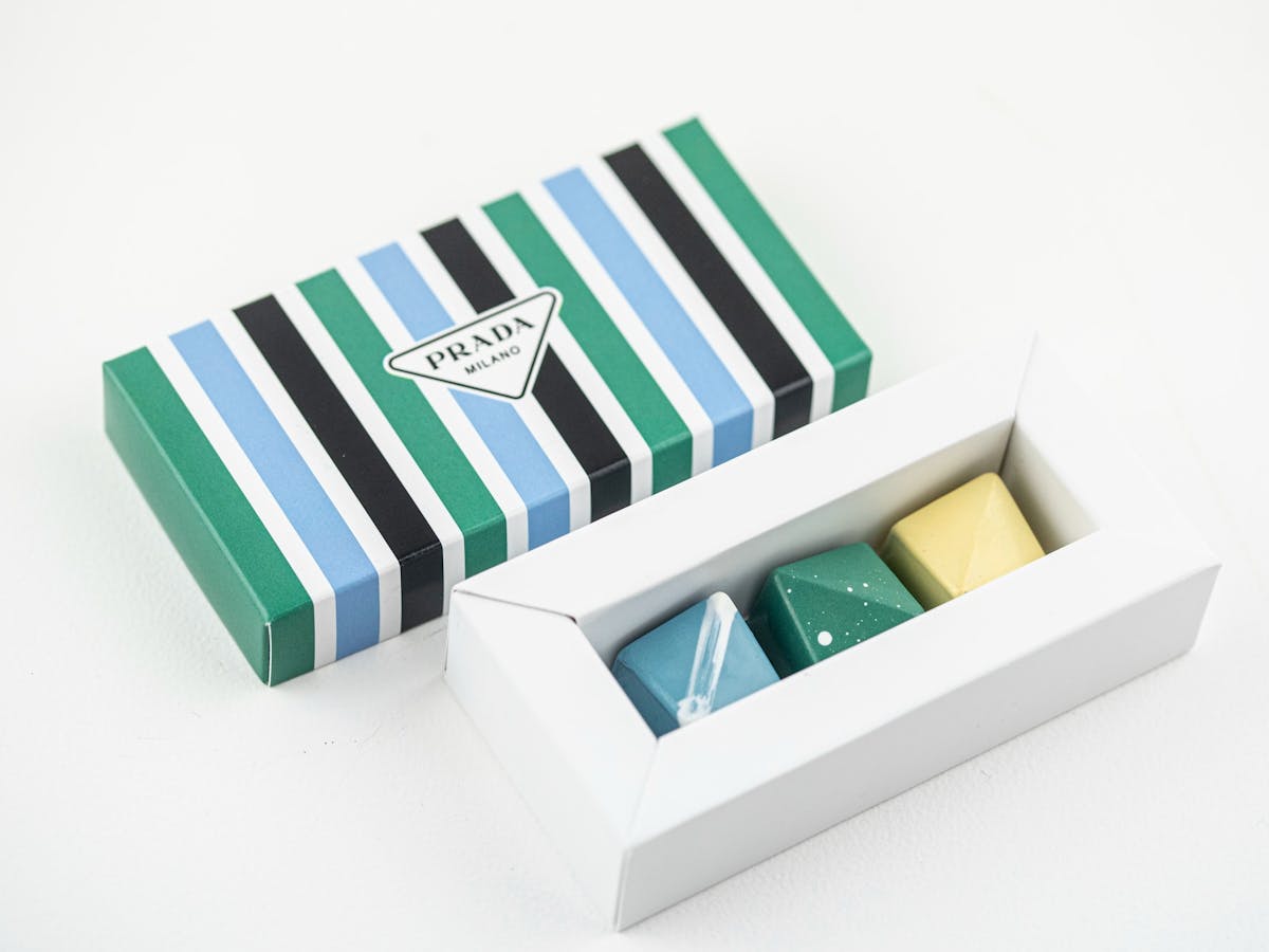 Box of Prada chocolates open with blue, green and yellow colours Box of Prada chocolates open with blue, green and yellow colours