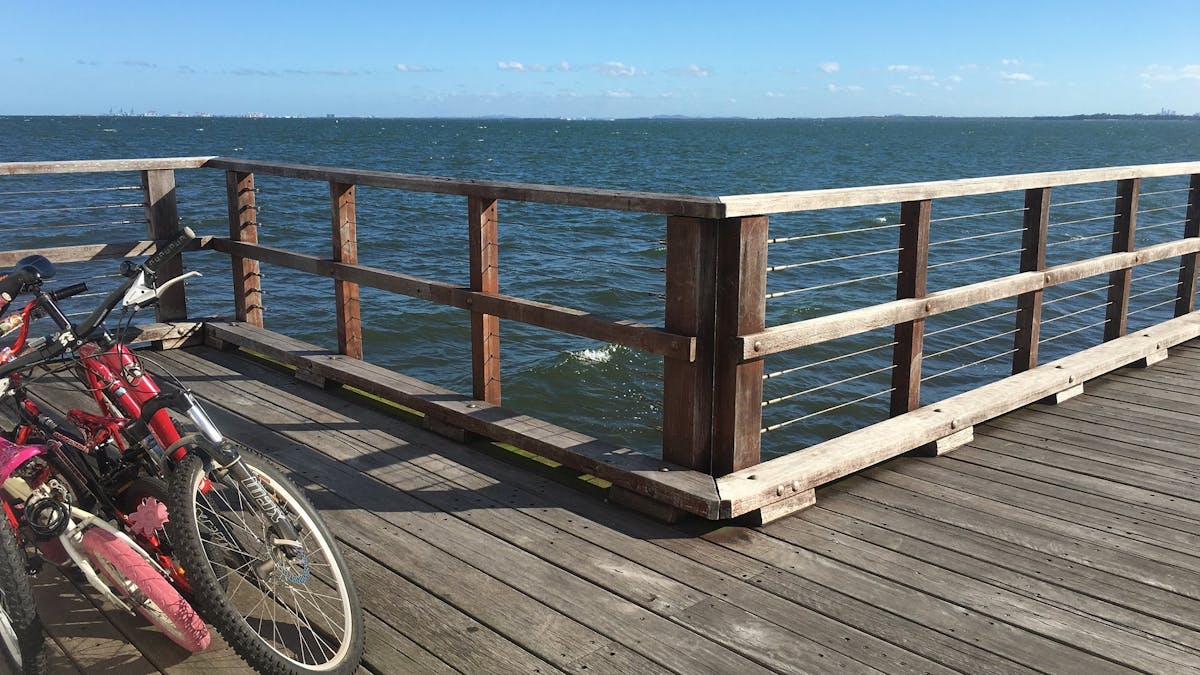 A number of bikes on the Woody Point Jetty, just off the Moreton Bay Cycleway