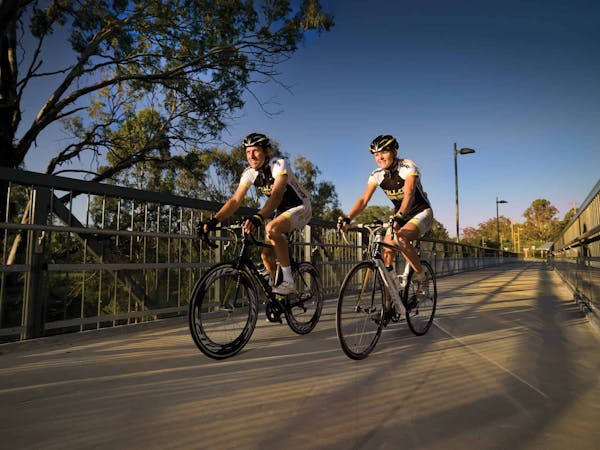 Two cyclists riding on the bikeway