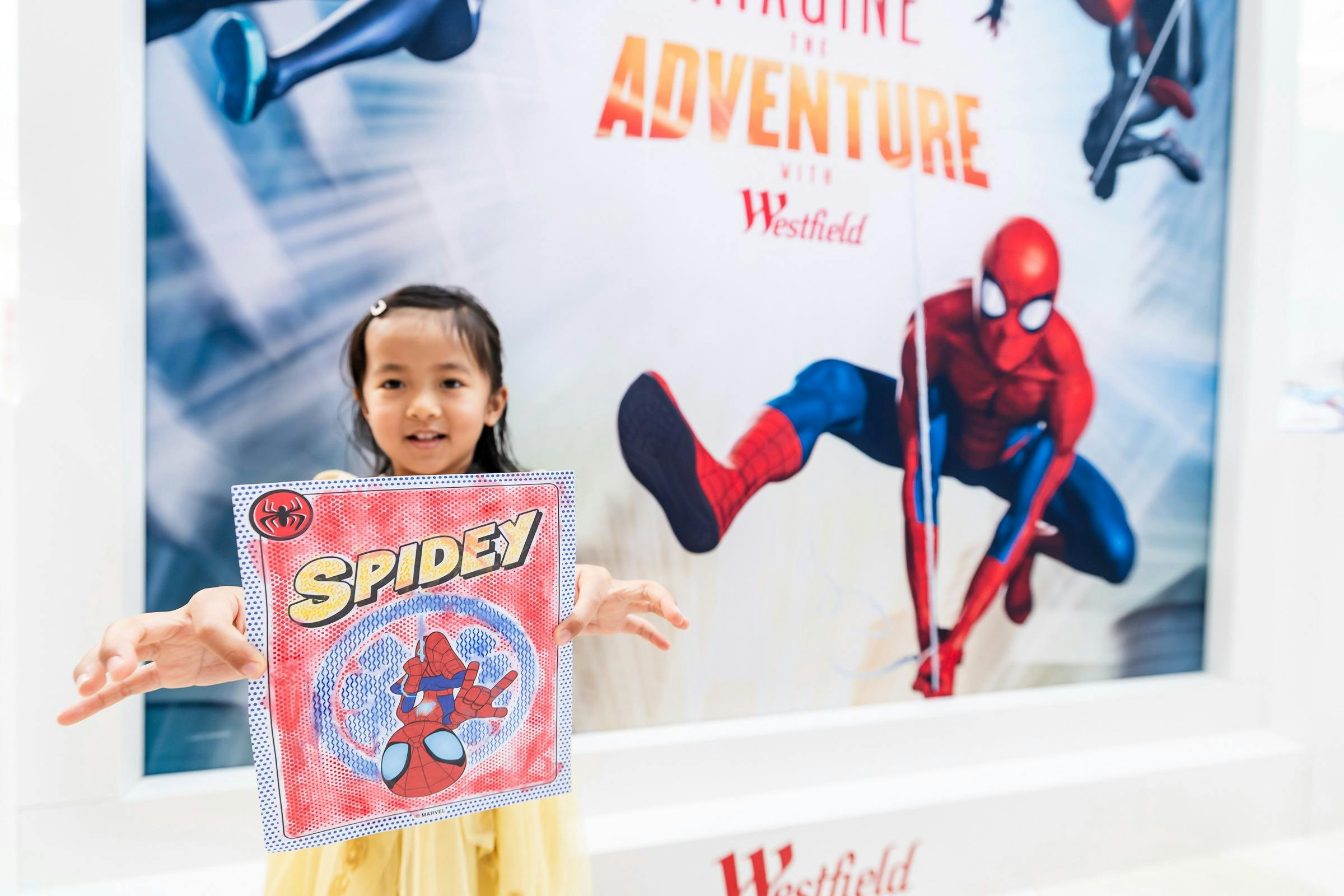 Girl holding up her Siperman craft sheet