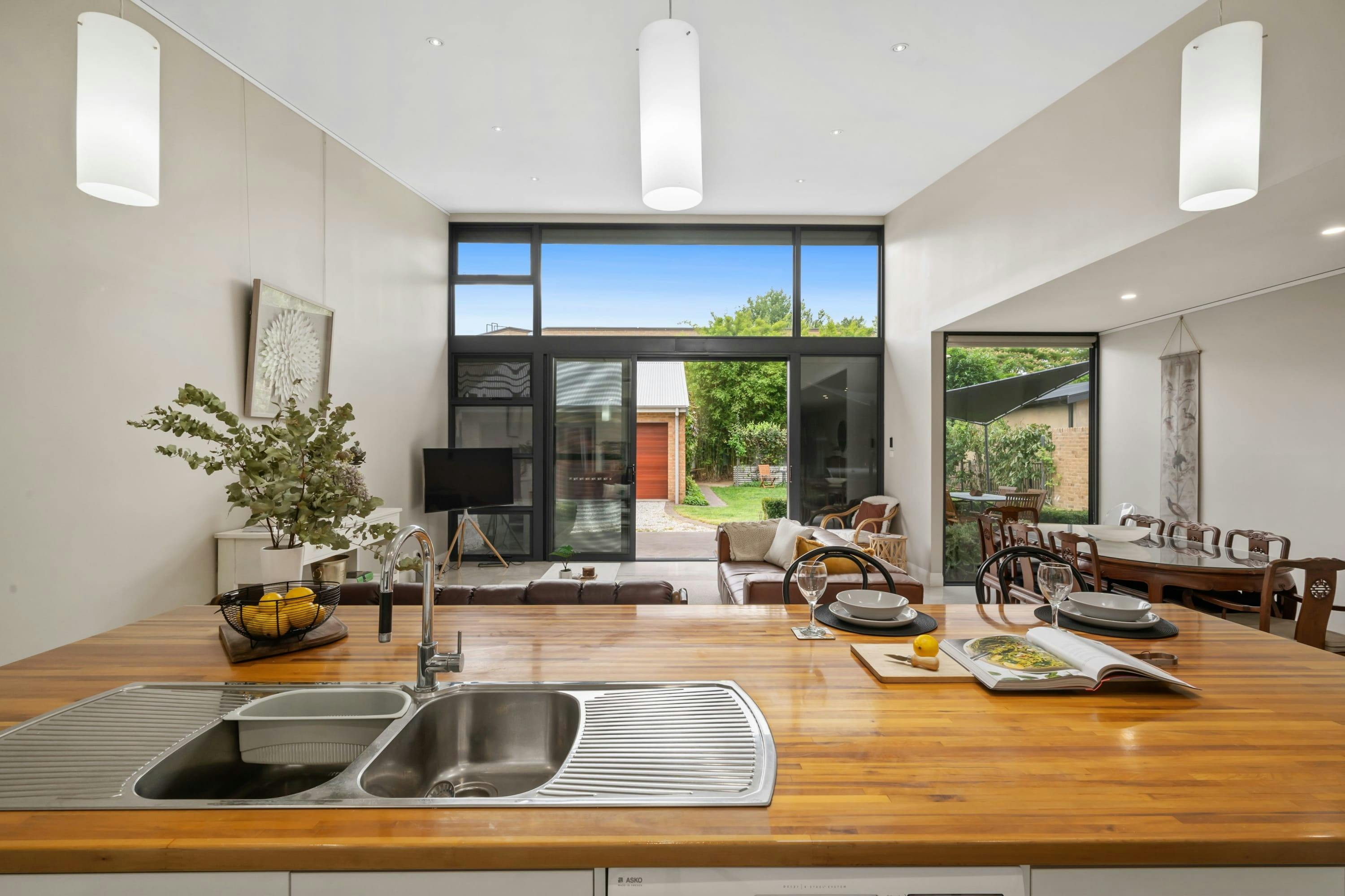 View from the kitchen bench, looking out to the living area leading out to the outdoor area