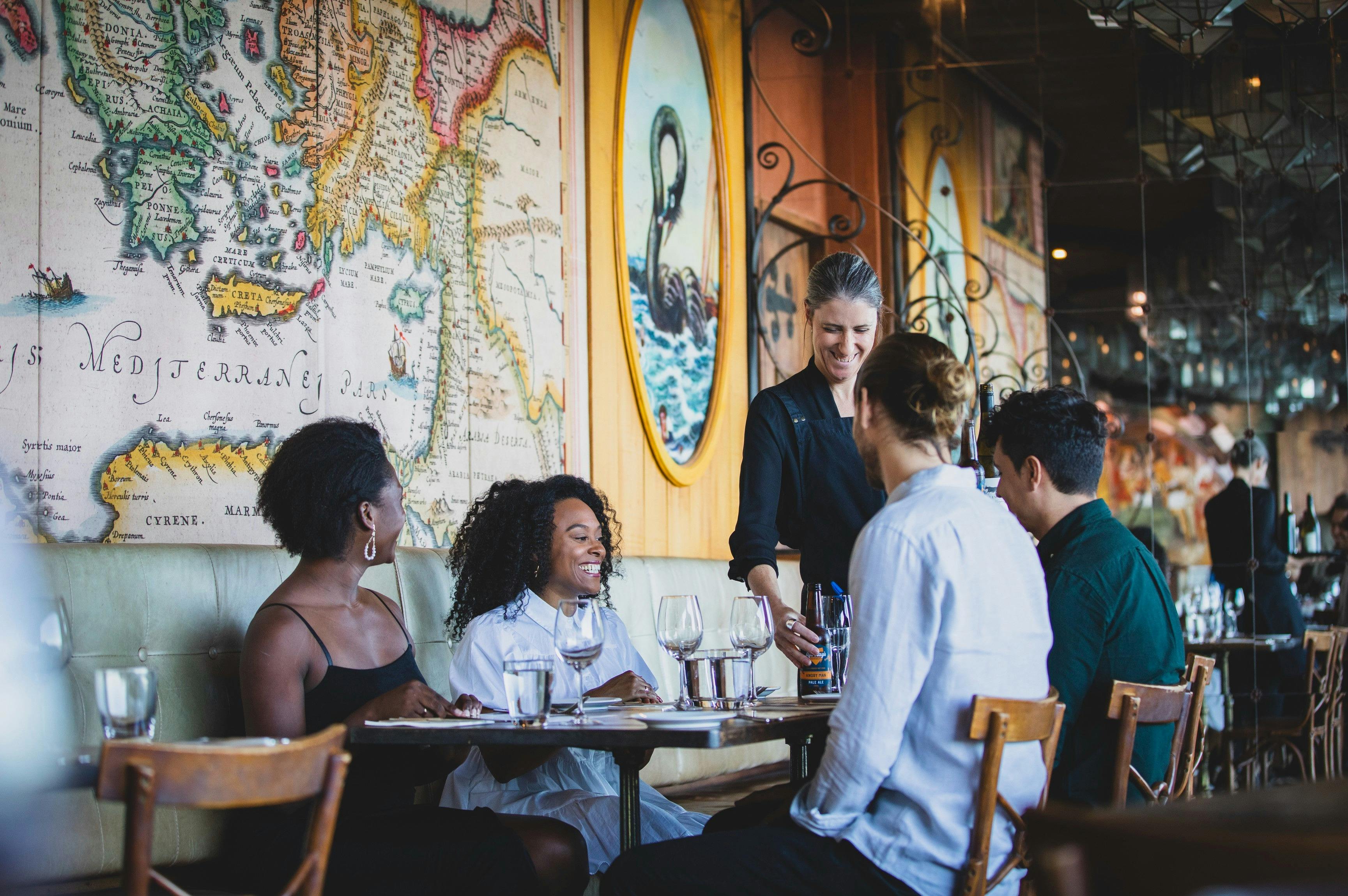 Waitress serving drinks at Rustica Restaurant, Newcastle