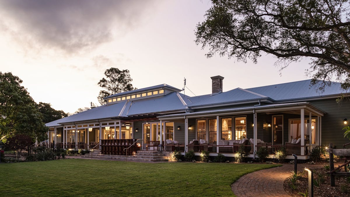 Exterior of the homestead in the evening and the lawn