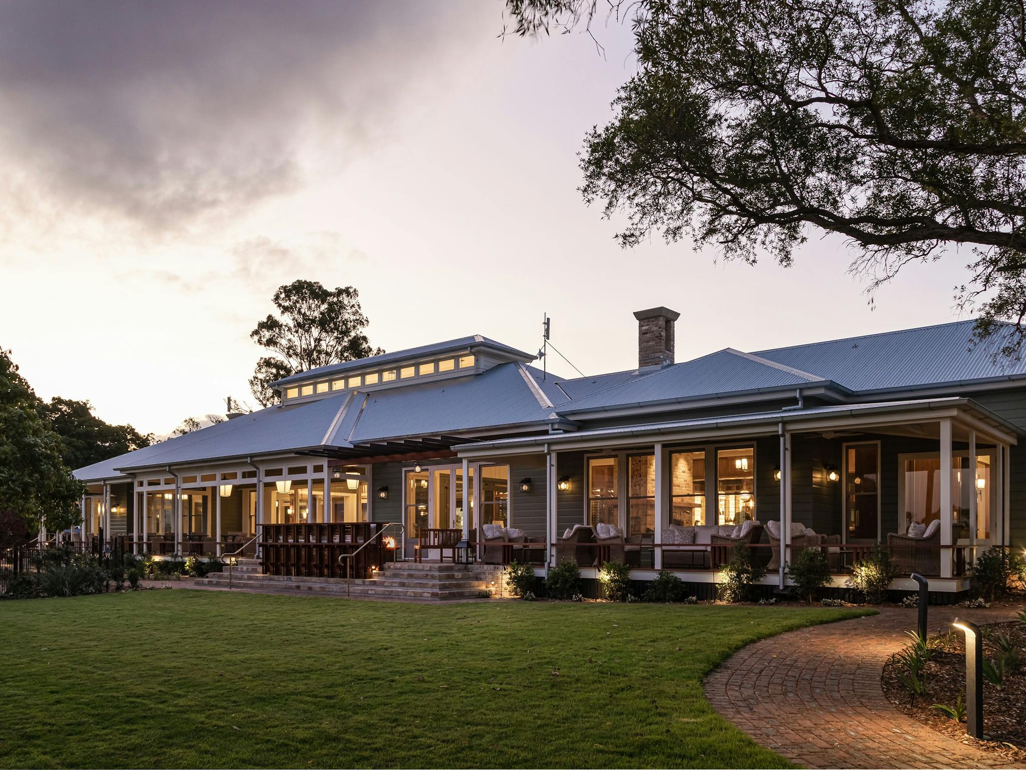 Exterior of the homestead in the evening and the lawn Exterior of the homestead in the evening and the lawn