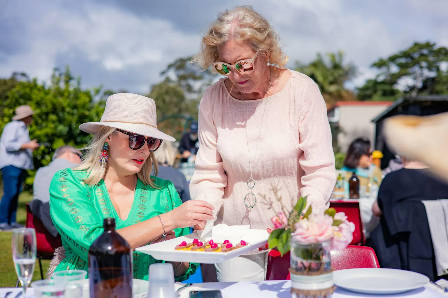 A plate of canapes being offered to a guest