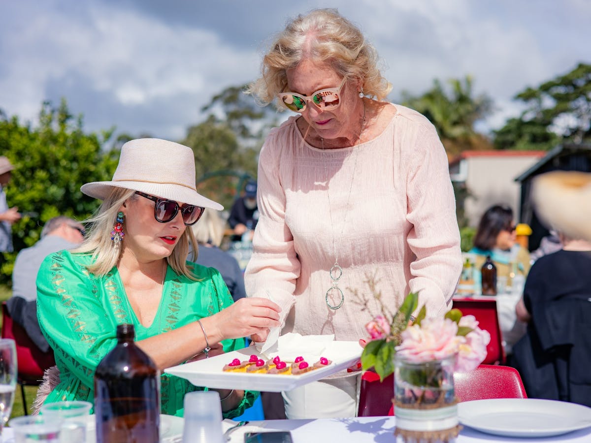 A plate of canapes being offered to a guest