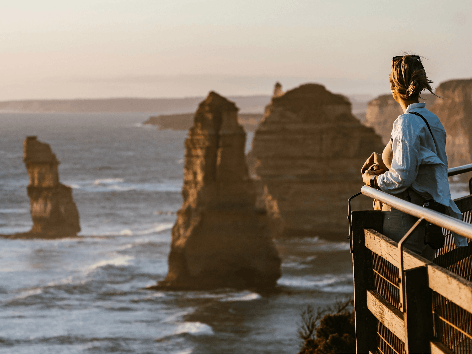 Woman stands viewing 12 Apostles Great Ocean Road Tour