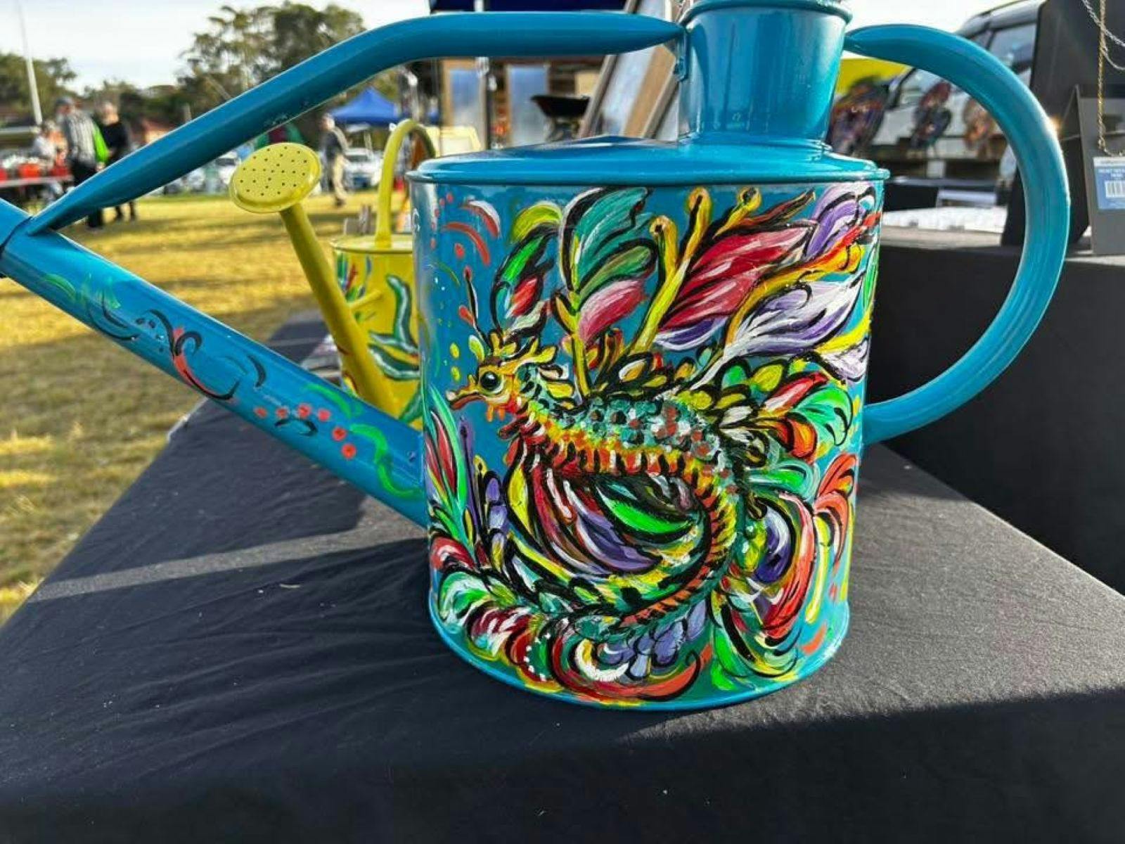 Coloured hand painted watering cans at The Nest Market
