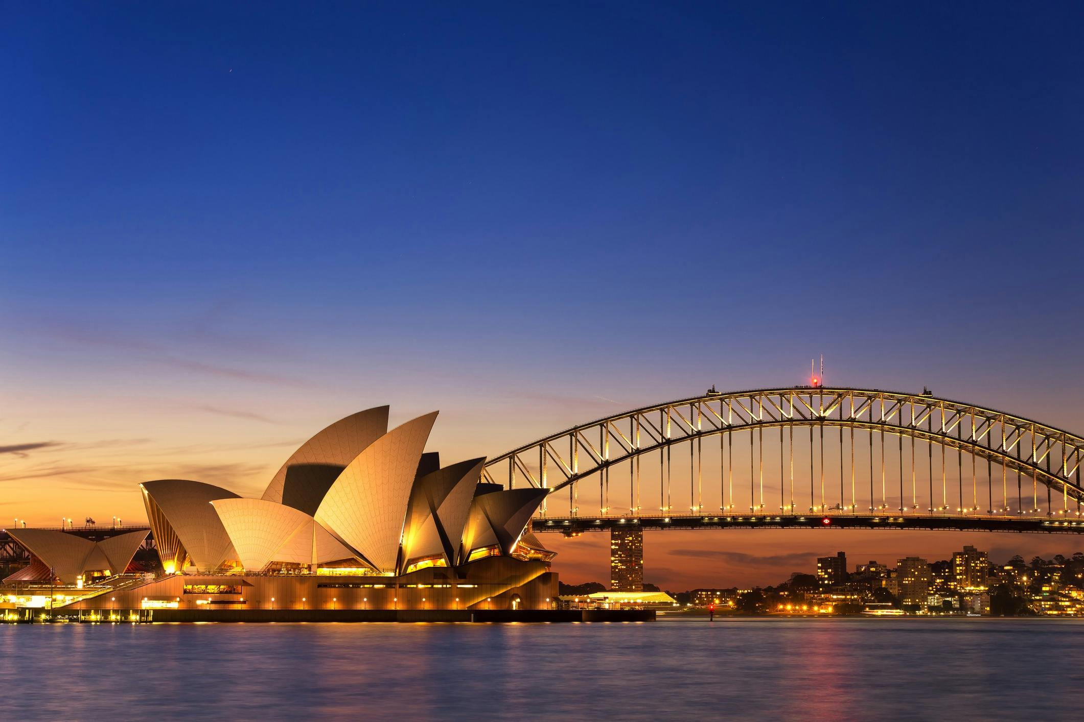 Sydney Opera House and Harbour Bridge at sunset from EV Arcadia electric cruise