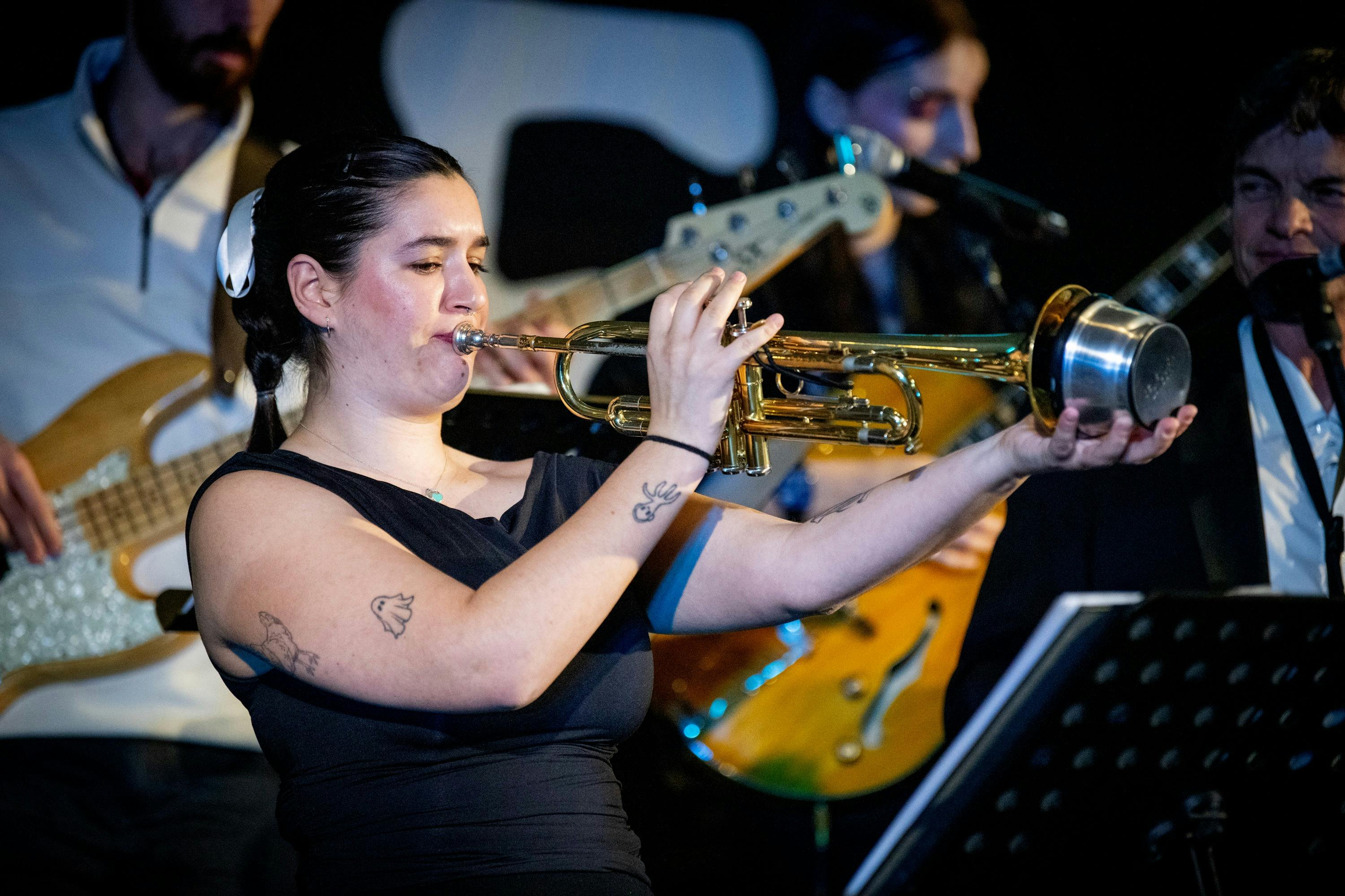 Female trumpet player using a mute