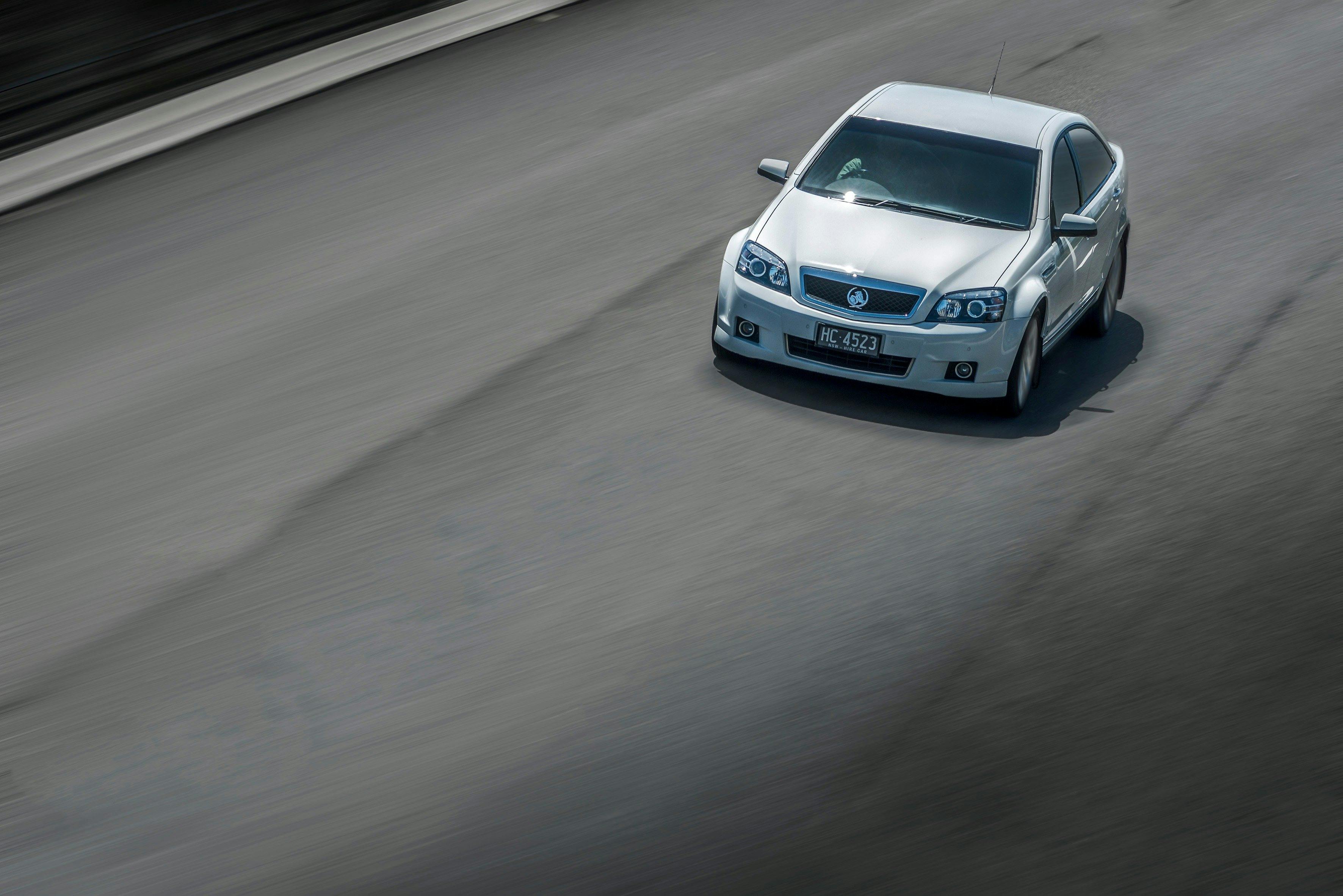 White Holden Caprice model hire car on a road