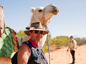 Cameleers lead the strings of camels through varied pictureque landscapes of the Flinders Ranges