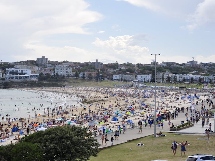Another stop of Sydney tour bus at Bondi Beach. Summer. Weekend. The beach is teeming with people.