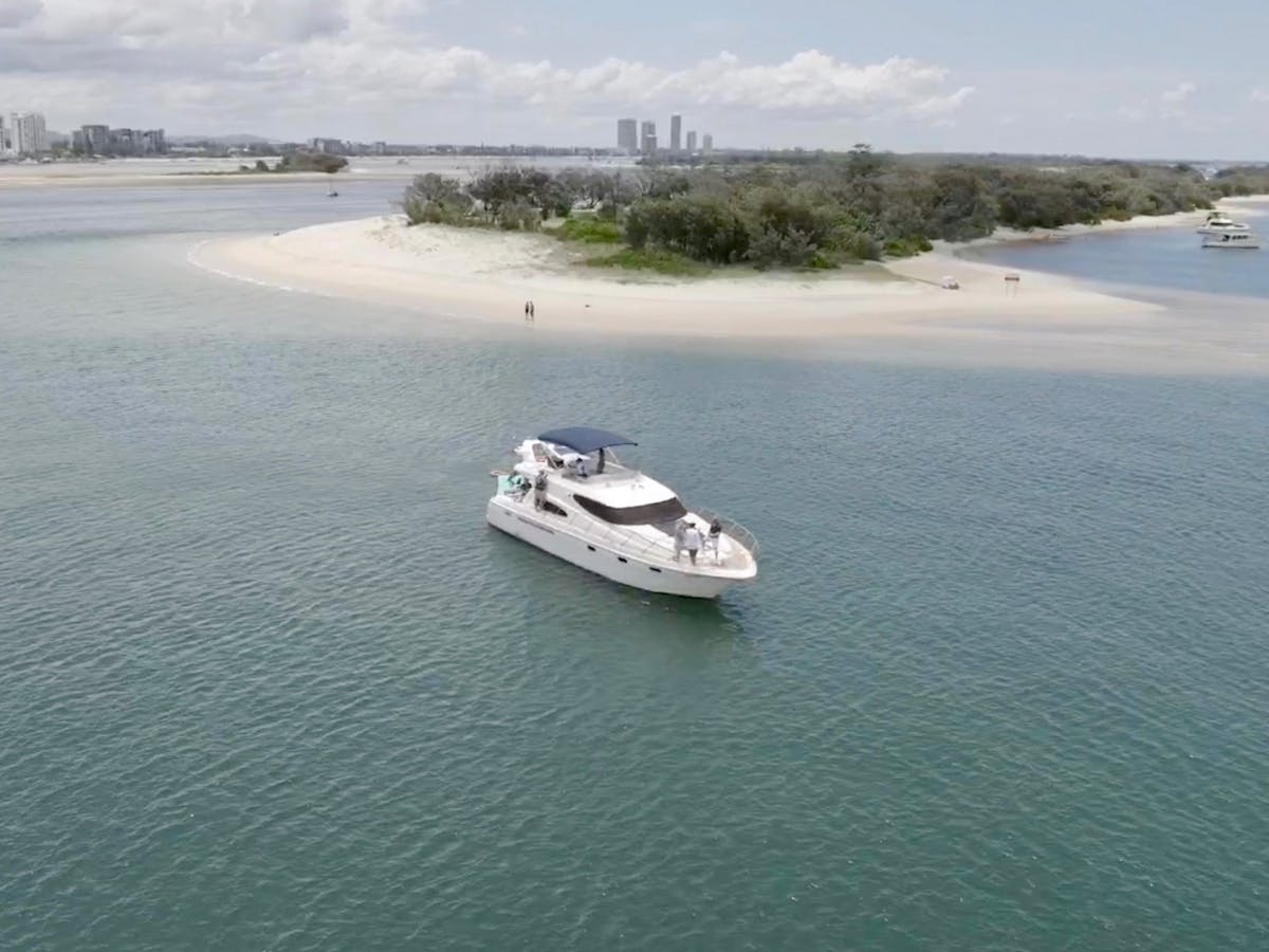 Private motor yacht sailing solo on calm turquoise water near the Gold Coast. Private motor yacht sailing solo on calm turquoise water near the Gold Coast.