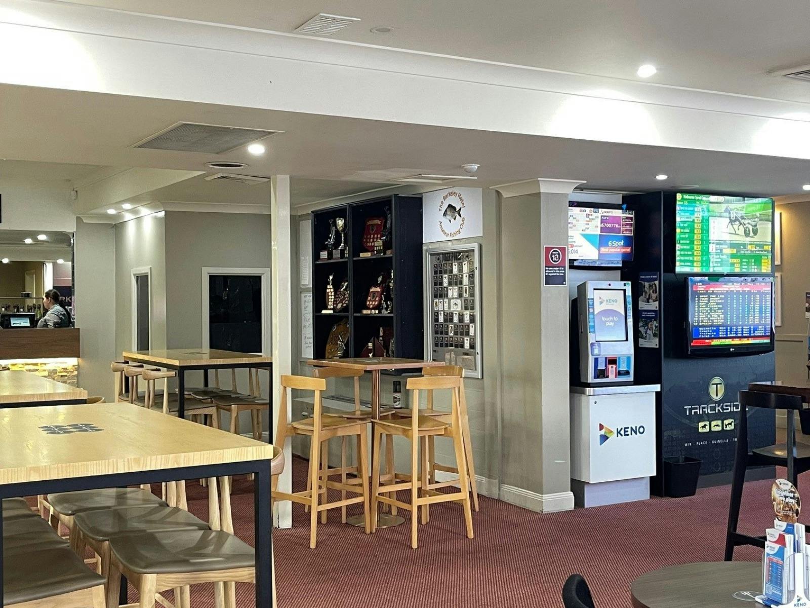 tables, chairs and TVs in the sports bar area at Berkeley Hotel