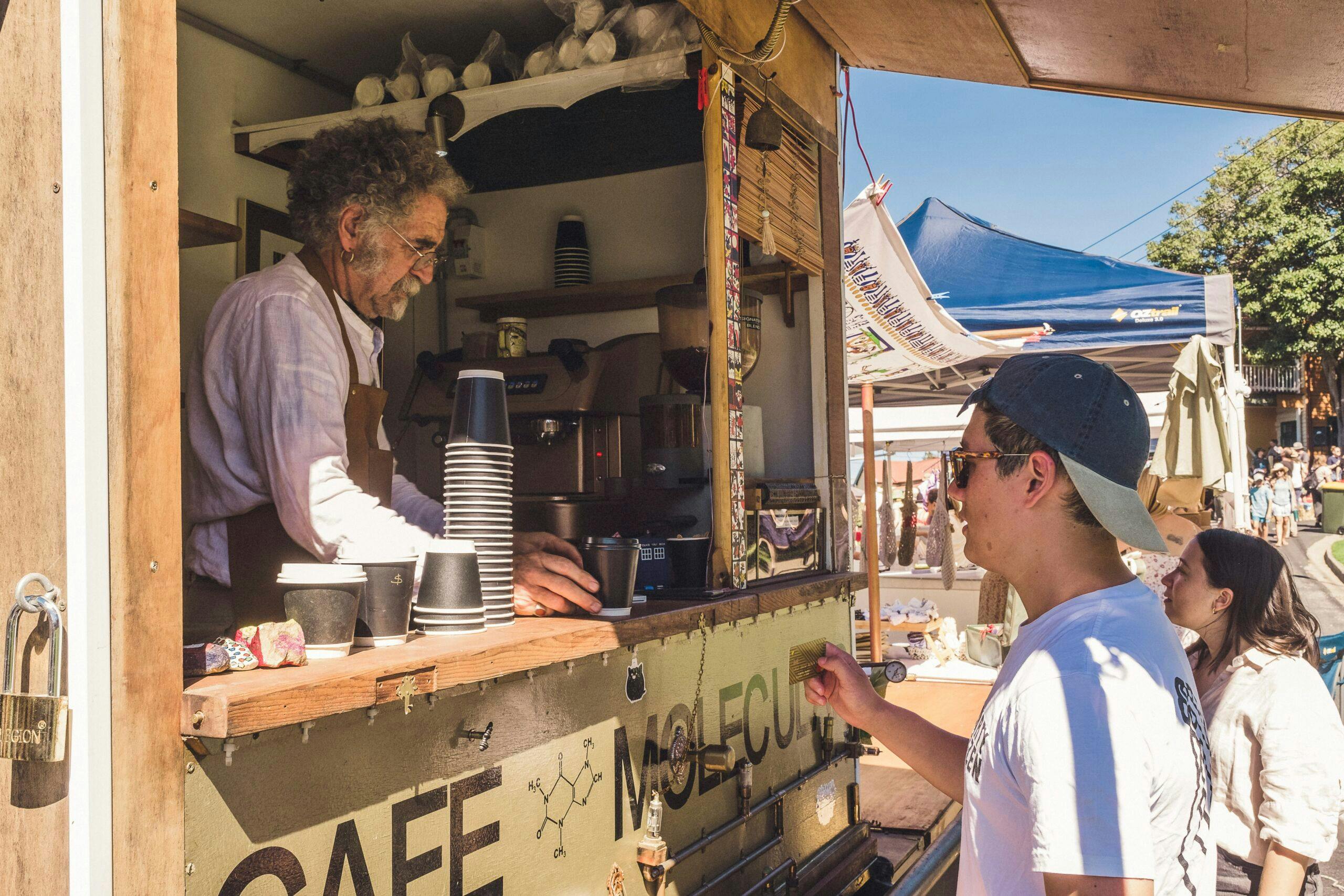 Coffe vendor serving coffee from a food van