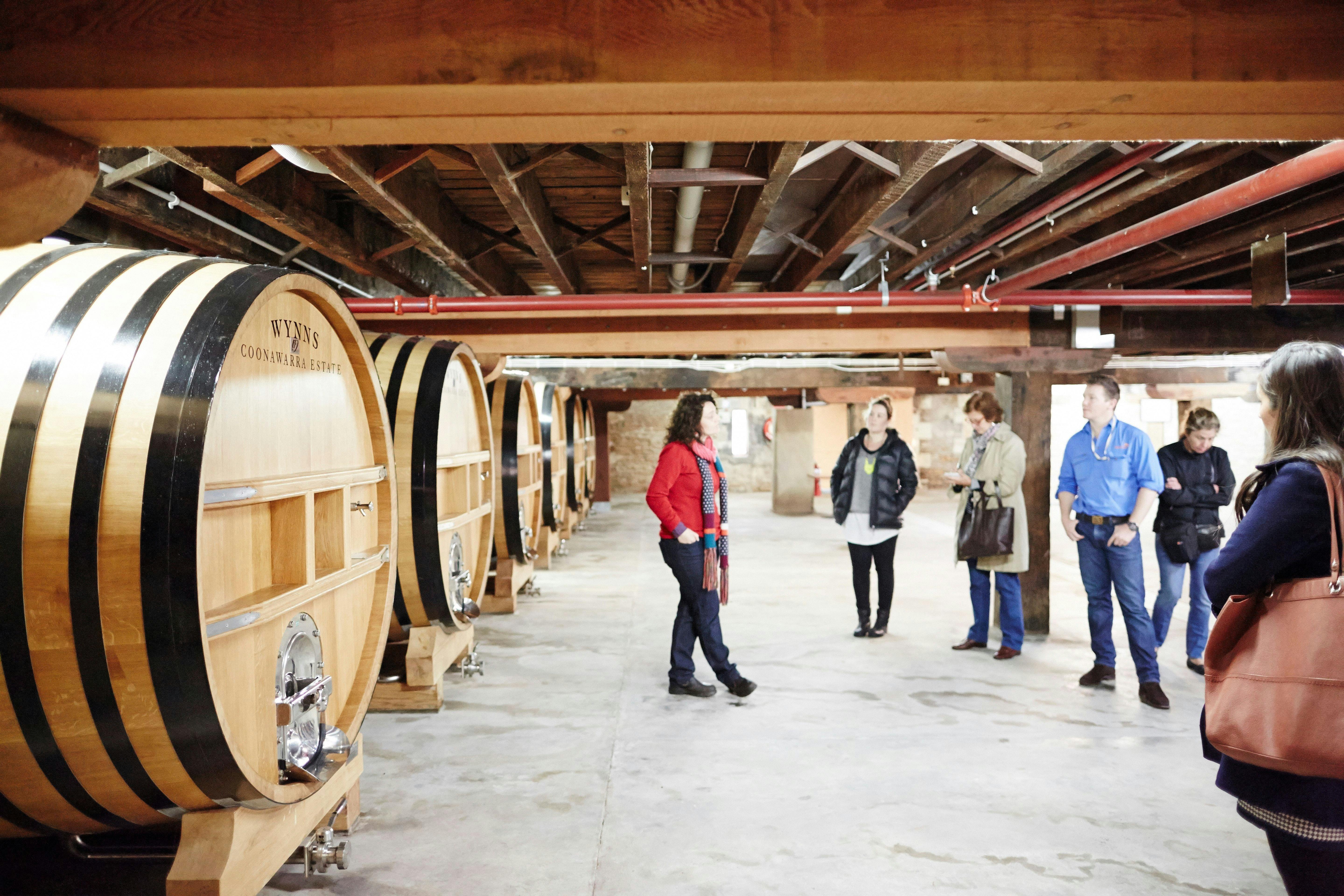 Group taking a tour through Wynns storage Wine Barrell area