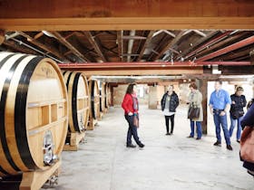 Group taking a tour through Wynns storage Wine Barrell area