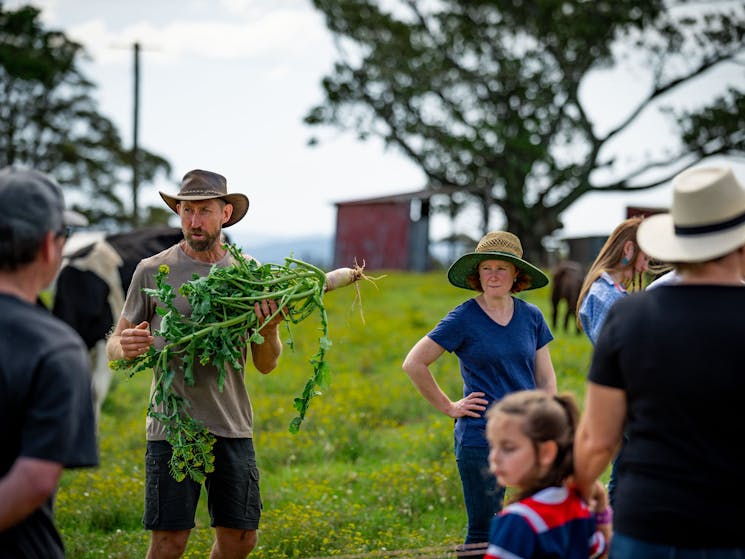 Farmer Pete explaining the nutritional qualities of a diverse mixed grazing pasture to tour guests