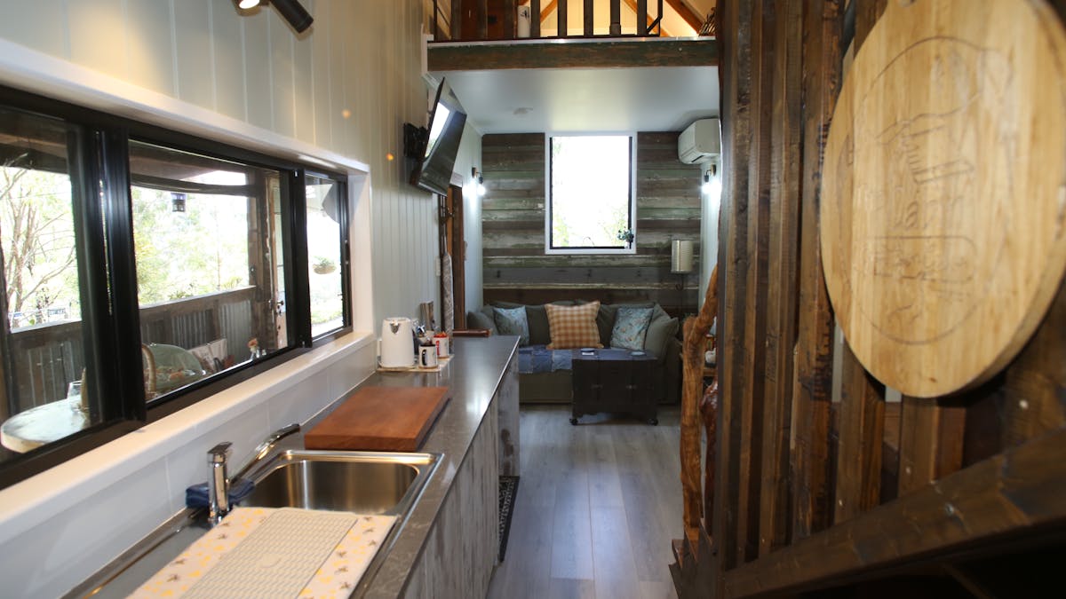 Kitchenette sink and lounge area with TV