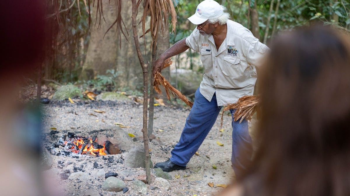 Kuku Yalanji Tribe Member Prepping the fire for a traditional sacred smoke cleansing ceremony Kuku Yalanji Tribe Member Prepping the fire for a traditional sacred smoke cleansing ceremony