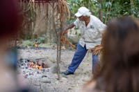 Kuku Yalanji Tribe Member Prepping the fire for a traditional sacred smoke cleansing ceremony