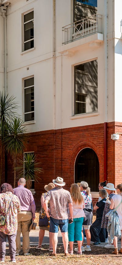She Shapes History tour guide presenting to the group of engaged guests